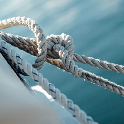 A closeup of the ship wires with the sea on the background under sunlight